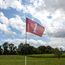The golf flag spins freely in the wind The golf flag spins freely in the wind